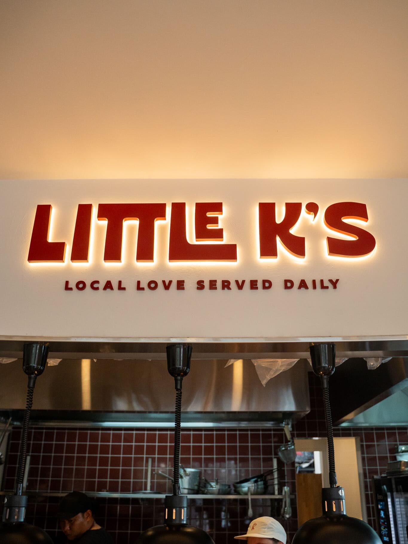 Barista holding the Little K's signature iced matcha can